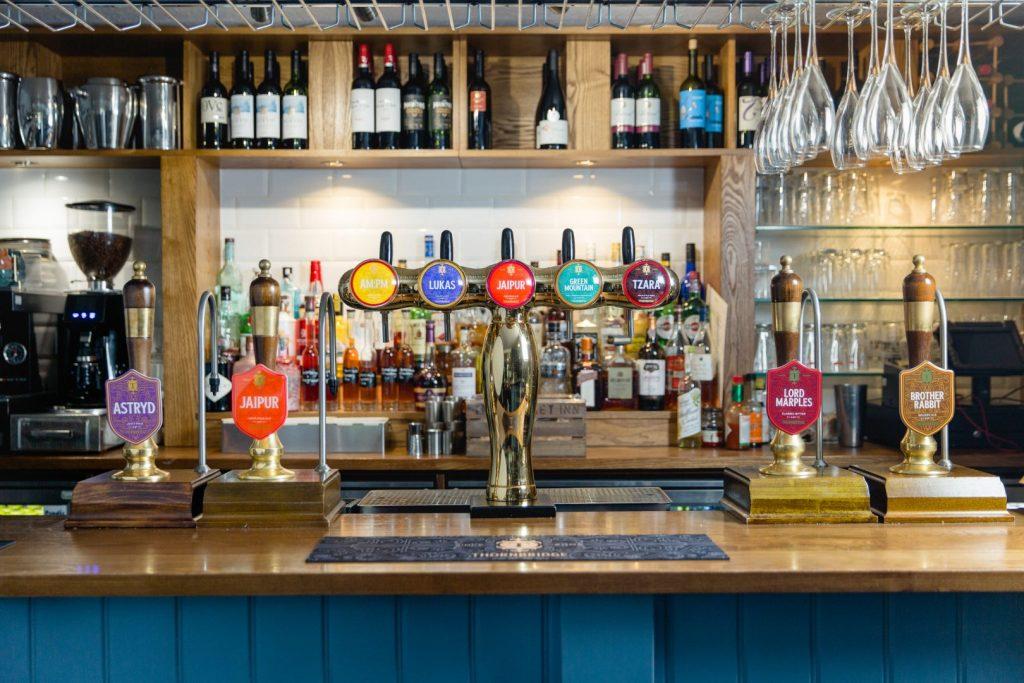 The bar at the Coach and Horses pub featuring cask and keg beer