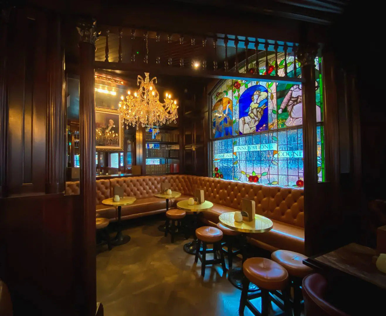 The ground floor seating and stained glass windows of the Bankers Cat in leeds